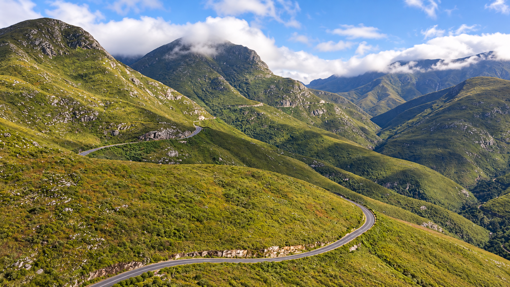 george-mountain-pass-v2 AI-edited view of a winding road through green mountains, representing the George area